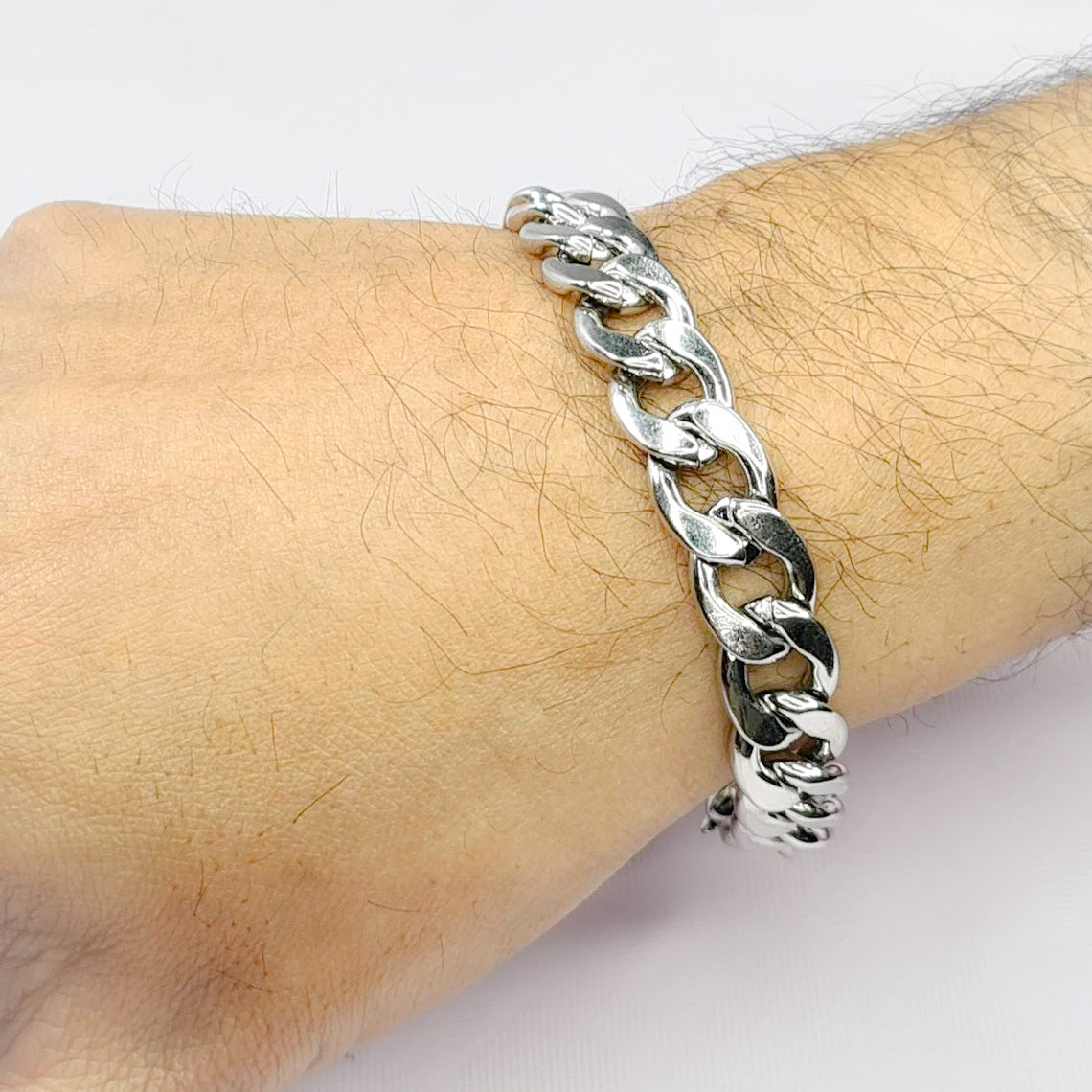 Pulsera acero inoxidable modelo Eslabón Grande, 12mm de ancho. Posa sobre mano de modelo.