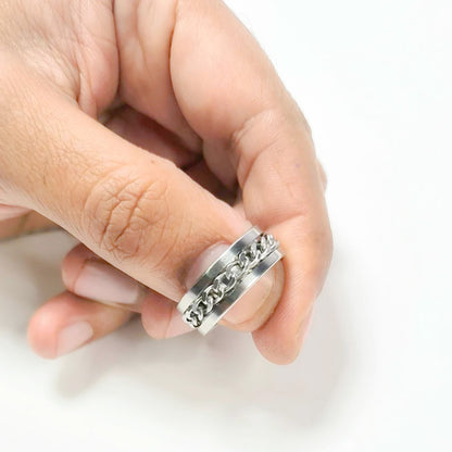 Anillo tipo alianza de matrimonio o pareja en acero inoxidable con cadena y ancho de 8mm. Se incluye grabado de nombres y fecha importante gratis. Posa sobre mano de hombre.