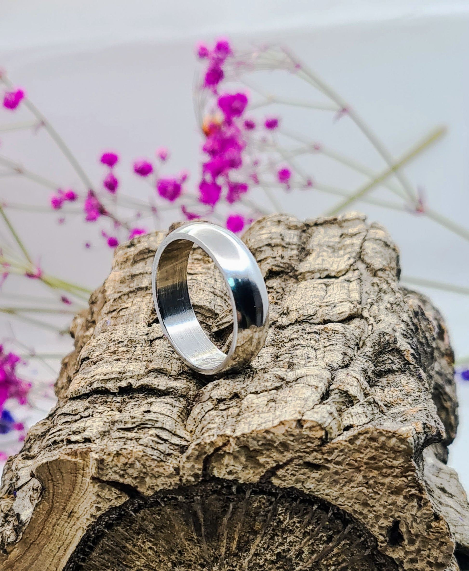 Anillo tipo alianza de matrimonio o pareja en acero inoxidable media caña ancho de 6mm. Se incluye grabado de nombres y fecha importante gratis. Se posa sobre tronco.