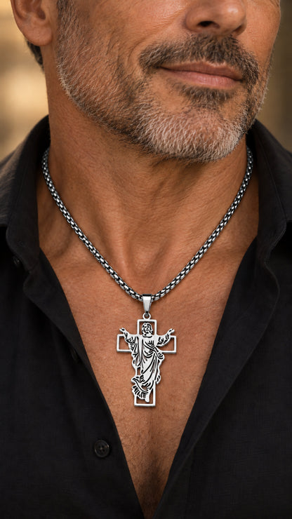 Cruz con Jesús plateada de acero inoxidable con cadena de 60 cm llevada por un hombre.