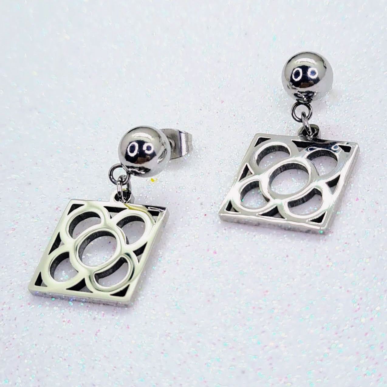 Pendientes con la Flor de Barcelona de acero inoxidable, conocida también como la rajola o panot es uno de los símbolos de la ciudad de Barcelona. Tope de Bola.