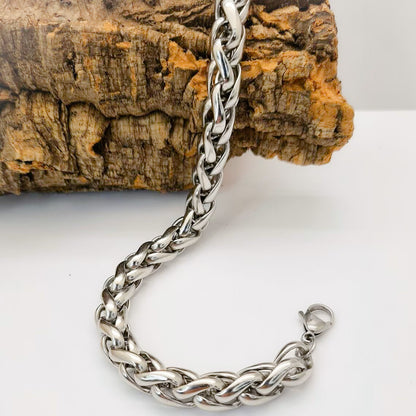 Pulsera acero inoxidable modelo Trenzado, 10mm de ancho. Posa sobre tronco.