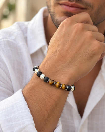 Hombre llevando pulsera de lava negra, ojo de tigre y cuentas de perla.